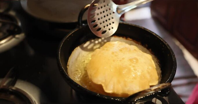Preparation deep frying puri indian crispy puri or khasta puri or Bhature
