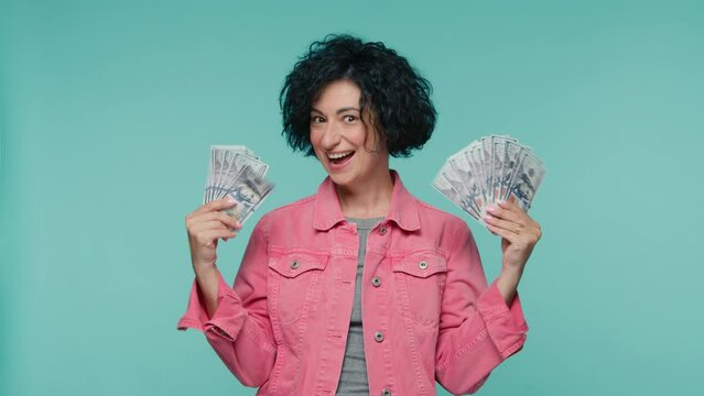 Curly female investor rejoice getting real payment dollars currency. Win lottery cash prize profit receiving money bonus work salary surprised wow effect. Amazed mature business woman executive worker