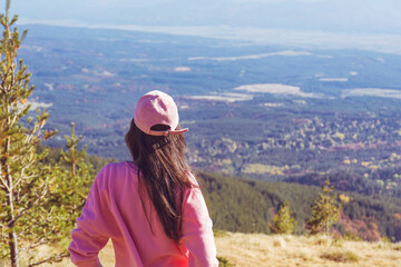 Naklejka na ściany i meble Woman with pink hat standing high in the autumn mountain . Vitosha mountain ,Bulgaria