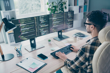 Photo of confident busy programmer wear spectacles typing keyboard framework indoors workplace...