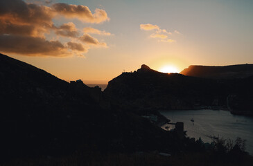 Beautiful sunset in the mountains. Clouds over the sea at sunset.