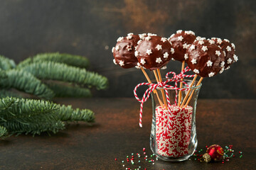 Marry Christmas sweet cake pops. Christmas dessert round brownie cake pops with stars topping on...