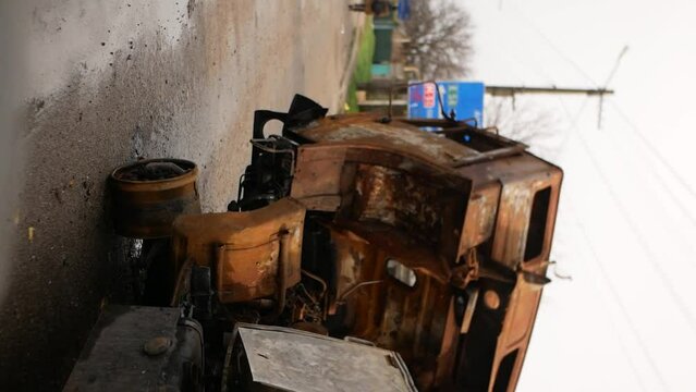 Kherson, Ukraine - November 20, 2022:Rusty broken car with torn barrel on side of road. Crushed car. War in Ukraine. Destruction by missiles and bombs of transport and infrastructure of country's 