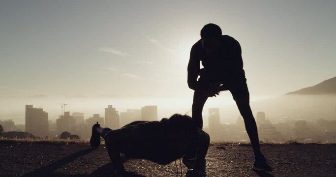 Personal trainer, man and fitness in nature with morning lens flare for power, muscle goals and body wellness motivation. Mountains, energy and support of sports people in push up training challenge