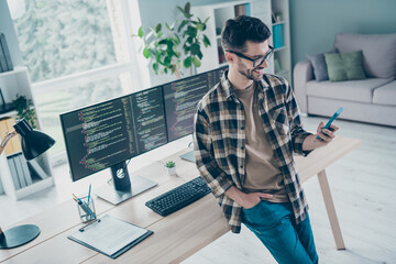 Photo of confident cheerful guy wear glasses chatting instagram twitter telegram modern device...