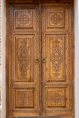 Fototapeta na wymiar A carved wooden door from the walnut wood