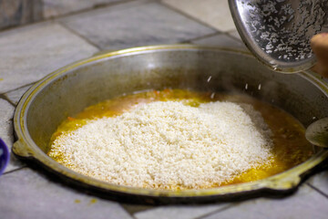 The plov is being prepared and now the trip goes into the cauldron.