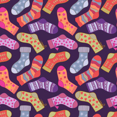 Winter socks seamless pattern on purple background. Different texture and color cartoon socks.