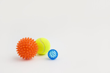 Set of three myofascial release balls for trigger points on white background. Equipment for MFR, self massage and physiotherapy. Reflexology therapy concept.