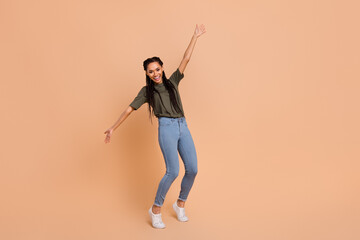 Full size photo of cheerful charming girl dancing chilling good mood isolated on beige color background