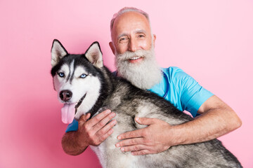 Portrait of professional vet therapist cuddle fluffy husky care animal pet health isolated on pastel color background © deagreez