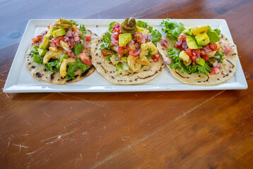 Caribbean shrimp tacos with diced avocados, onions and lettuce