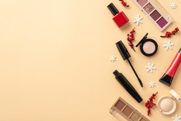 Winter holiday shopping concept. Top view photo of decorative cosmetics red lip gloss nail polish mascara eyeshadow palettes mistletoe berries snowflakes on isolated beige background with copyspace