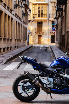 Motorcycle, back, on the street of an old European city