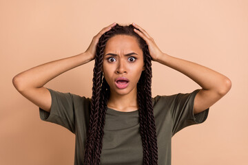 Photo of terrified bad mood female touch head can't believe hear unpleasant news isolated on beige...