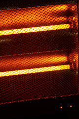Close-up of two 500 watt electrical resistance heaters turned on. nice orange highlights in the...