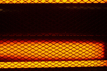 Close-up of two 500 watt electrical resistance heaters turned on. nice orange highlights in the...
