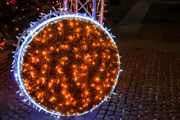 Large illuminated Christmas bauble on a city square