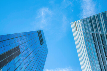 Obraz na płótnie Canvas Glass buildings towering under the bright blue sky in downtown Austin Texas