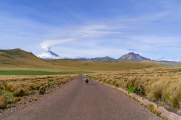 Scenic landscape with person watching, mountains, cotopaxi volcano activity, green meadows,...