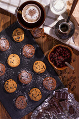 Fototapeta na wymiar Cookies with chocolate and coffee on a wooden table, flat lay, top view