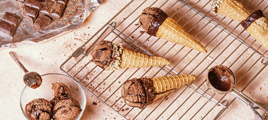 Chocolate ice cream on a metal rack with scoop from stainless stee, selective focus, close up