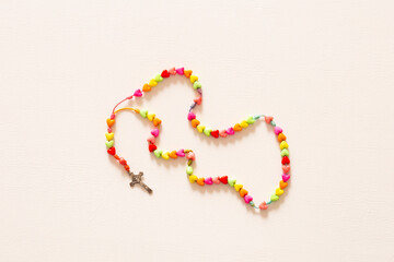 Catholic rosary and crucifix on white background