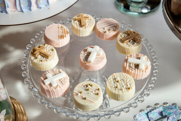 Mini cakes on the dessert table of the first communion