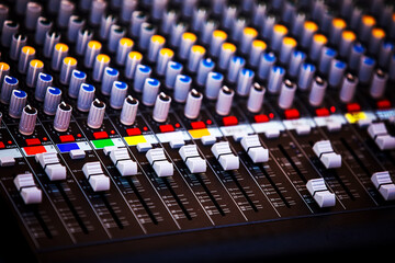 Concert sound mixer panel with volume regulators. Professional audio and light equipment for sound...