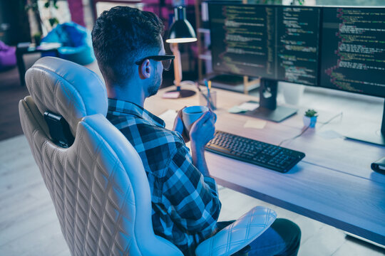 Photo of thoughtful busy programmer wear spectacles drinking tea thinking working modern device indoors workplace workshop home