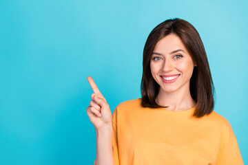 Photo of optimistic satisfied good mood girl straight hair wear yellow t-shirt directing empty...