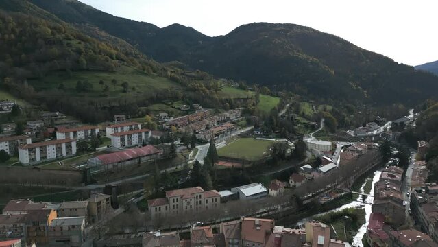 Aerial drone shot of man staying on the top of climb with Flag and Cross