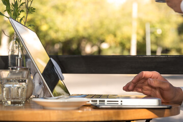 man outdoors working on his laptop