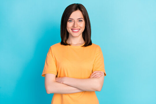 Photo of positive cheerful optimistic lady arm folded good mood beaming smile isolated on blue color background