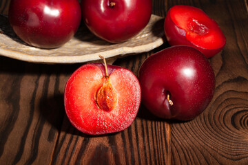 sliced plum on wood background