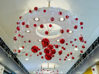 Big lamp decorated with red balls and lights for Christmas and New Year celebrations. Creating party mood concept.