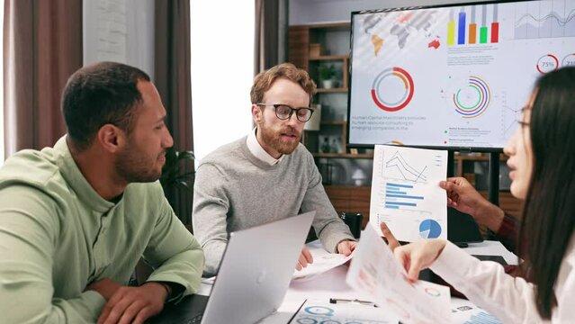 A team of young multinational business people are working on a startup. Business strategy, teamwork.Communication network.Management strategy. Digital transformation. multinational professional staff.