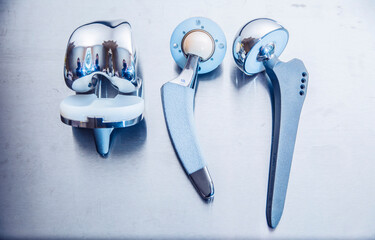 close up of lots of parts for transplantation of leg joints and tools for surgical operations on...