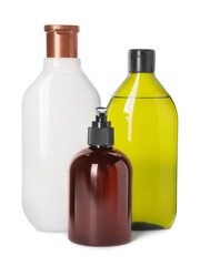 Different bottles of shampoo on white background