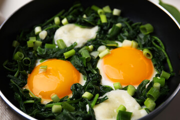 Tasty green Shakshouka in frying pan, closeup