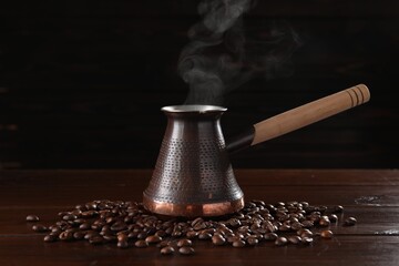 Turkish coffee in cezve and beans on wooden table