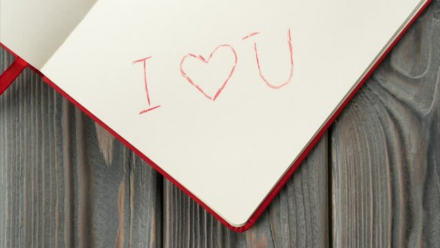 Red diary book with white paper moving to center, sign I love you appearing on page with red shaded line heart. Love letter message for beloved, confession and feelings for Valentine's Day. Stopmotion