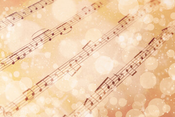 Paper sheet with musical notes, closeup view. Chirstmas song. Bokeh effect
