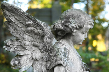 Beautiful statue of angel at cemetery. Religious symbol