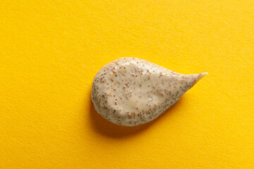 Sample of scrub on orange background, top view