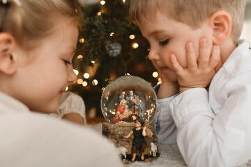 The christmas glass ball with a nativity scene and kids