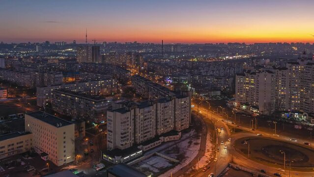 Kyiv sunset urban skyline time-lapse. Residential area near the Minska metro station at winter sunset. Obolon. In the foreground we can see a roundabout.