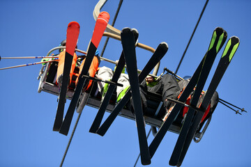Skiers climb the cable car with skis