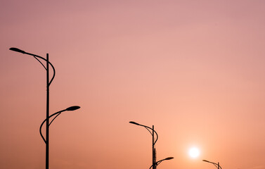 street lamps silhouette against sunset