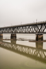 Fototapeta na wymiar old metal bridge over river